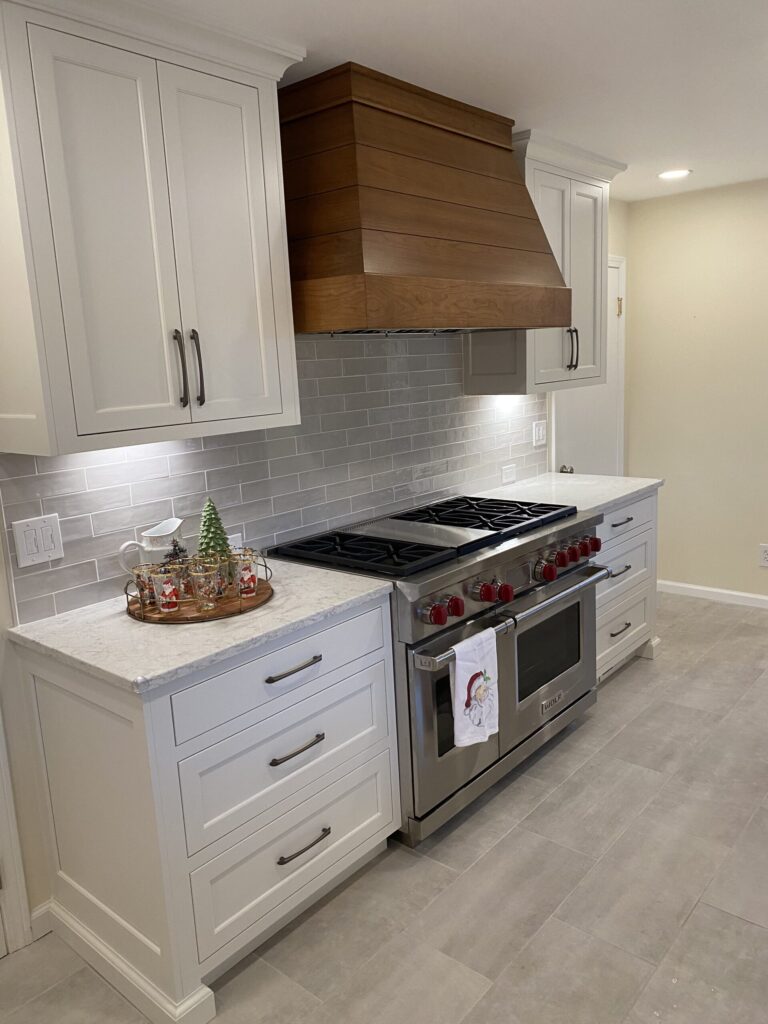 new oven with stove top and beautiful wood panel fan